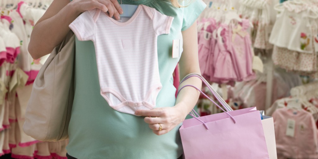 Pregnant woman shopping for baby clothes