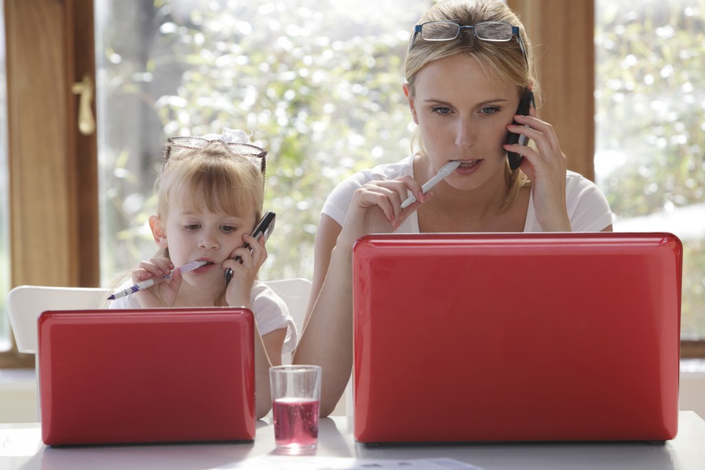 daughter copy mother working on laptop